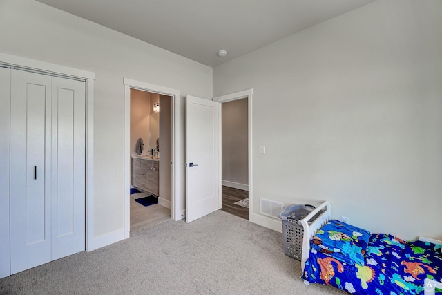 2800 Ashley Ave, East Helena, MT 59635 - unfurnished bedroom with visible vents, baseboards, a closet, connected bathroom, and carpet