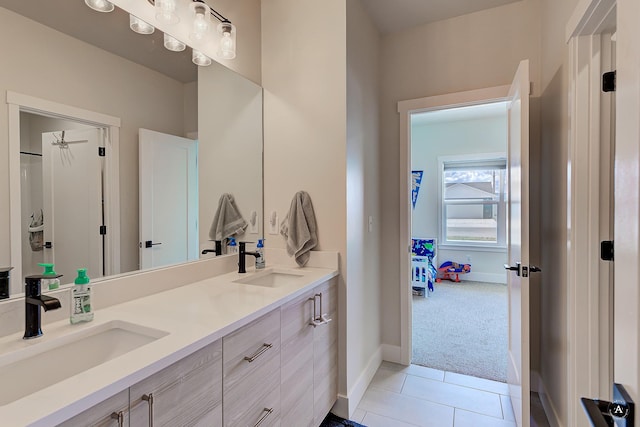 2800 Ashley Ave, East Helena, MT 59635 - bathroom with tile patterned flooring, a sink, baseboards, and double vanity