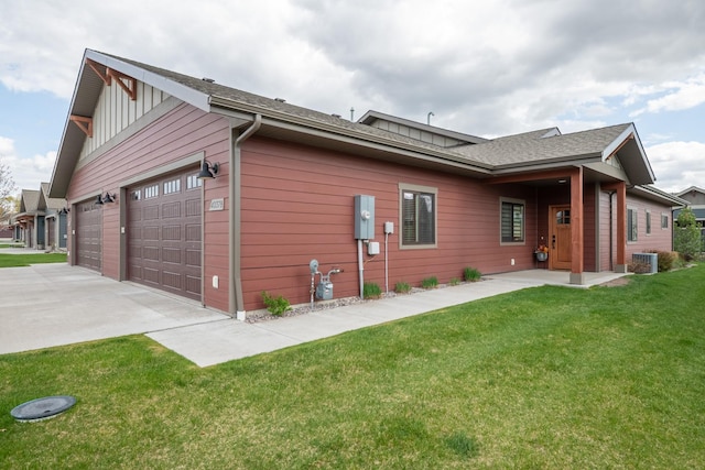 4037 Valley View Ct Unit B, Missoula, MT 59808 - view of side of home featuring board and batten siding, driveway, a garage, central AC, and a yard
