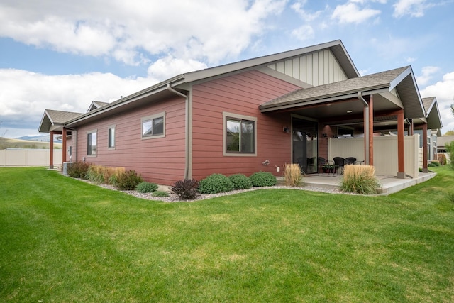 4037 Valley View Ct Unit B, Missoula, MT 59808 - rear view of property featuring board and batten siding, a yard, fence, and a patio area