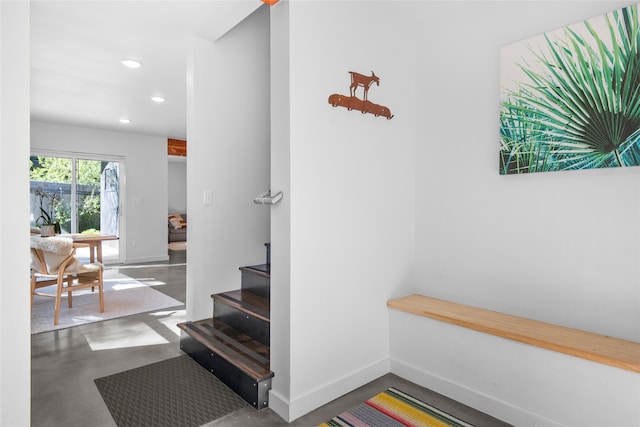 mudroom featuring concrete flooring, baseboards, and recessed lighting