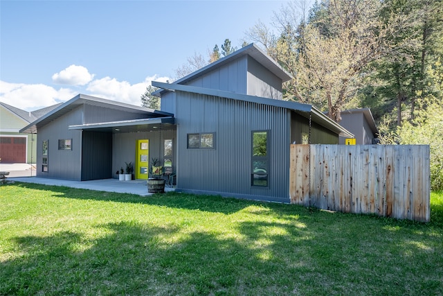 back of house featuring a patio, fence, and a yard
