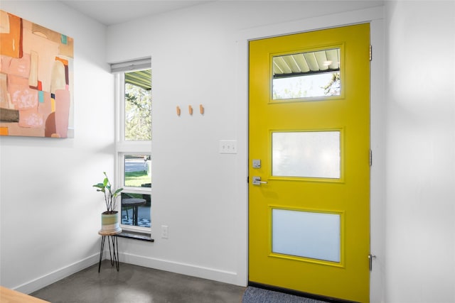 entrance foyer featuring finished concrete floors and baseboards