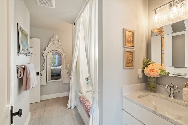 736 Cottonwood Ct, Whitefish, MT 59937 - bathroom with vanity, shower / tub combo, and wood finished floors
