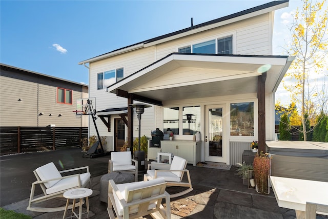 736 Cottonwood Ct, Whitefish, MT 59937 - rear view of property featuring a patio area and a hot tub