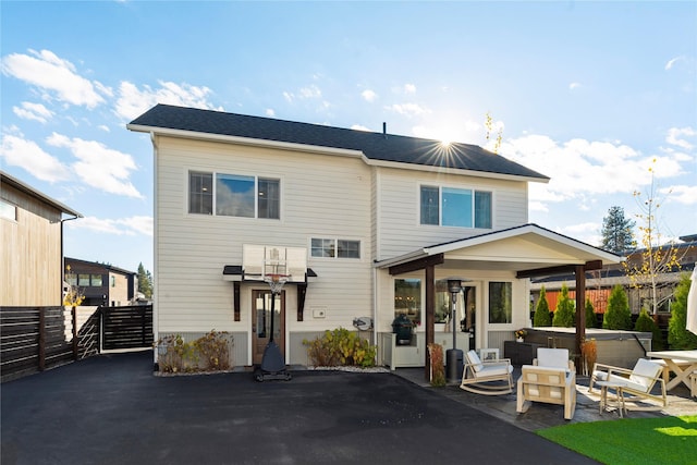 736 Cottonwood Ct, Whitefish, MT 59937 - back of property with a hot tub and a patio