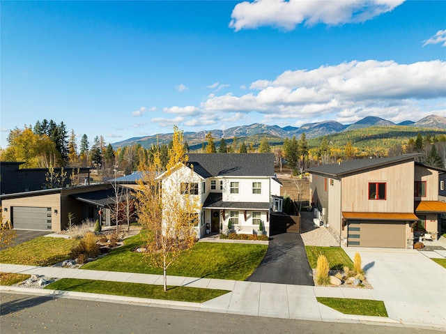 736 Cottonwood Ct, Whitefish, MT 59937 - view of front facade with a mountain view, concrete driveway, an attached garage, and a front yard