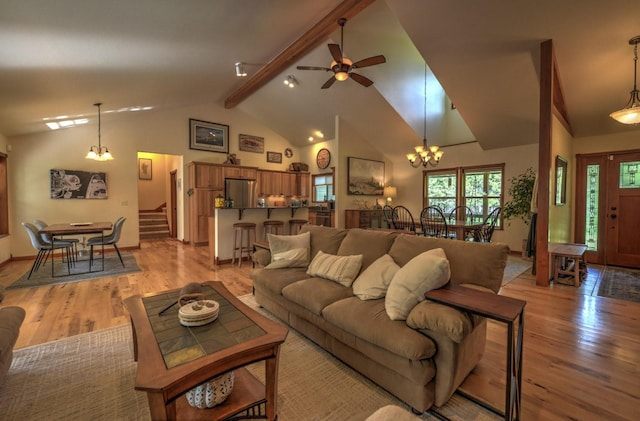 living room with beamed ceiling, high vaulted ceiling, stairway, and light wood-style floors