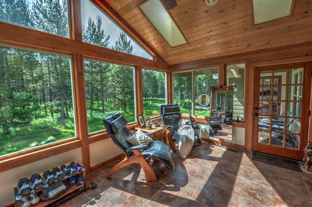 sunroom with wood ceiling, a skylight, plenty of natural light, and french doors