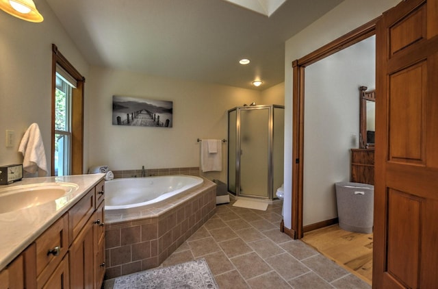 bathroom featuring vanity, toilet, recessed lighting, a shower stall, and a garden tub