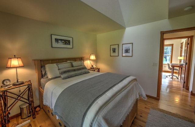 bedroom featuring baseboards and light wood-style flooring