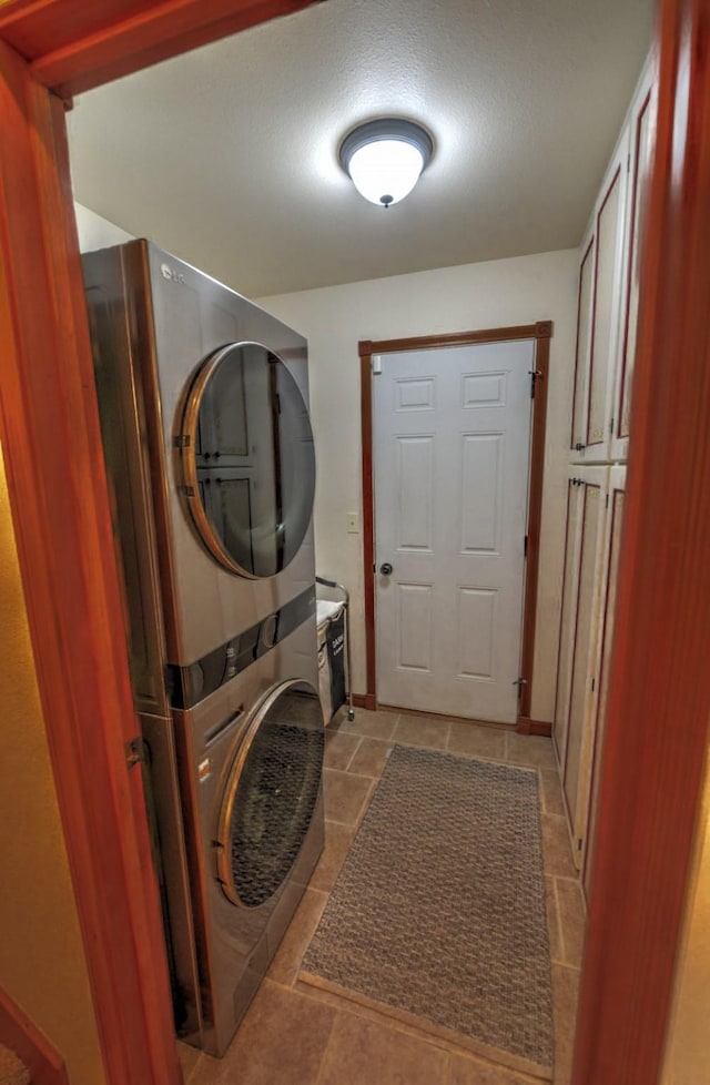 laundry area featuring stacked washer and dryer and laundry area