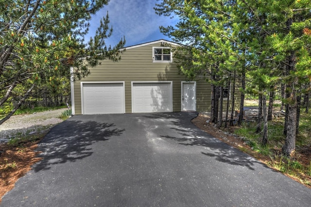 garage featuring aphalt driveway