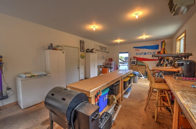 dining room featuring a workshop area and unfinished concrete flooring