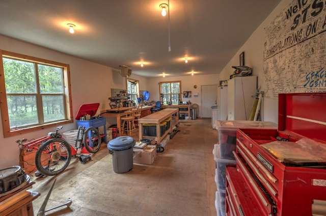 interior space featuring concrete flooring and a workshop area