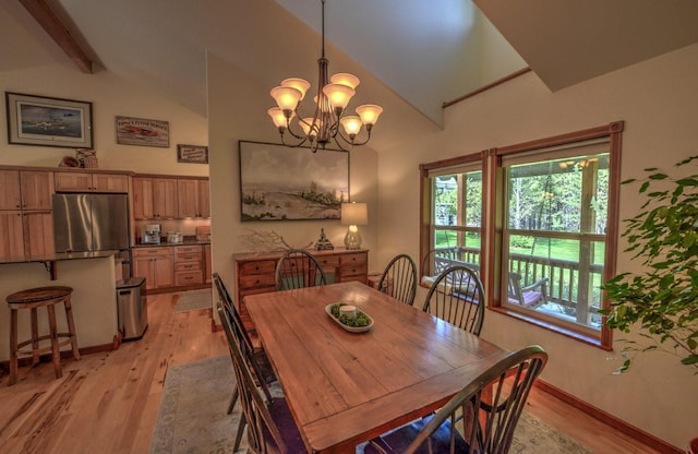 dining room with baseboards, a chandelier, vaulted ceiling with beams, and light wood-type flooring