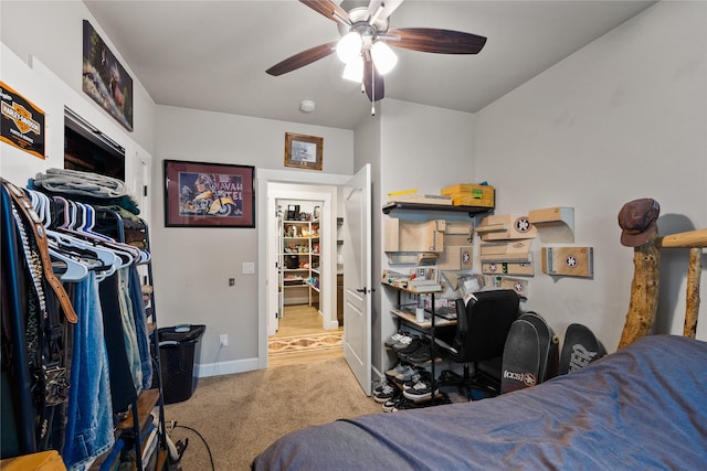 carpeted bedroom featuring baseboards and ceiling fan
