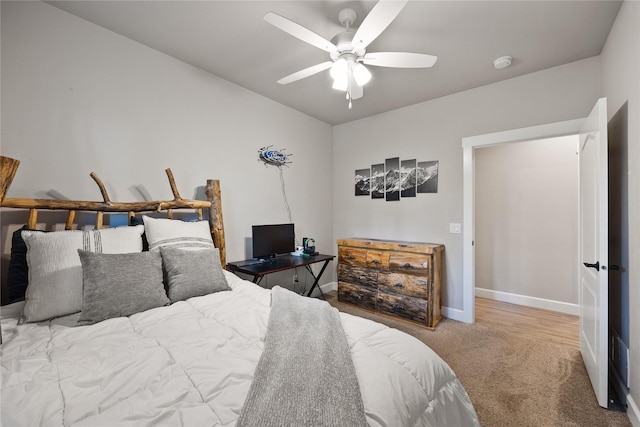 carpeted bedroom with a ceiling fan and baseboards