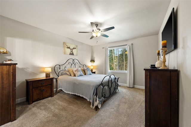 bedroom featuring baseboards, a ceiling fan, and light carpet