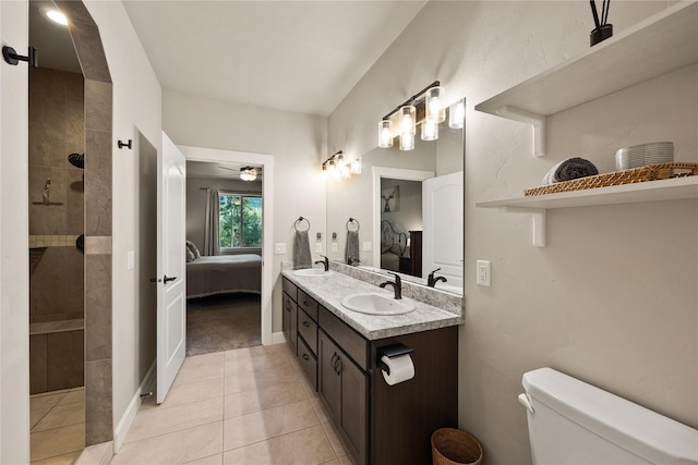 ensuite bathroom with a sink, connected bathroom, walk in shower, and toilet