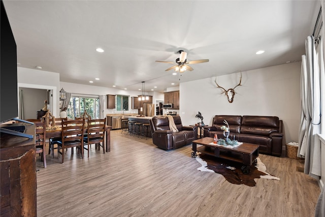 living room featuring ceiling fan, recessed lighting, and wood finished floors