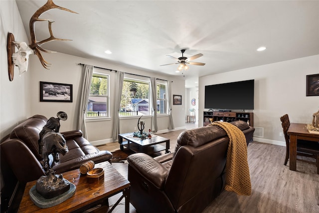 living room featuring a ceiling fan, visible vents, baseboards, light wood finished floors, and recessed lighting