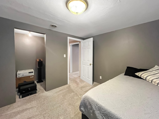 bedroom featuring visible vents and light colored carpet