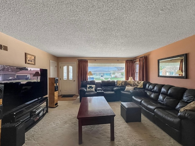 living area featuring a textured ceiling and light colored carpet