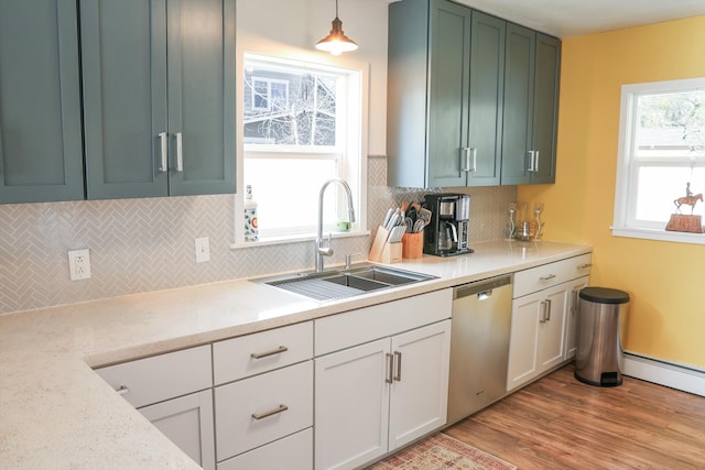 2060 Schilling St, Missoula, MT 59801 - kitchen featuring stainless steel dishwasher, a sink, backsplash, and light wood-type flooring