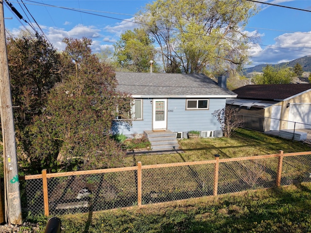 2060 Schilling St, Missoula, MT 59801 - bungalow-style home featuring a fenced backyard, a shingled roof, and a front lawn