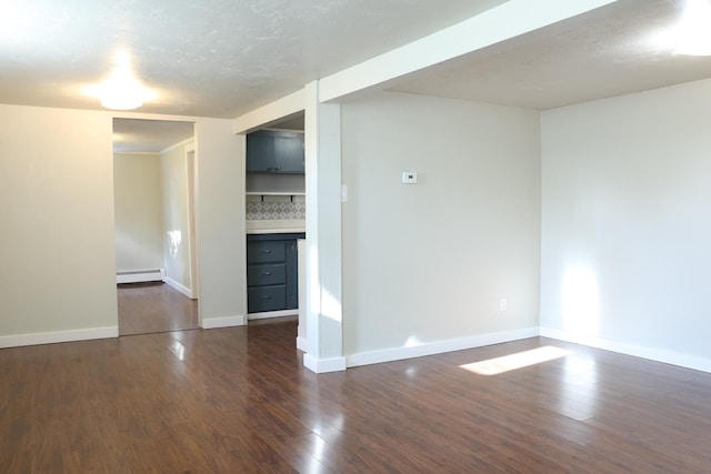 2060 Schilling St, Missoula, MT 59801 - spare room featuring baseboards, baseboard heating, and dark wood-type flooring