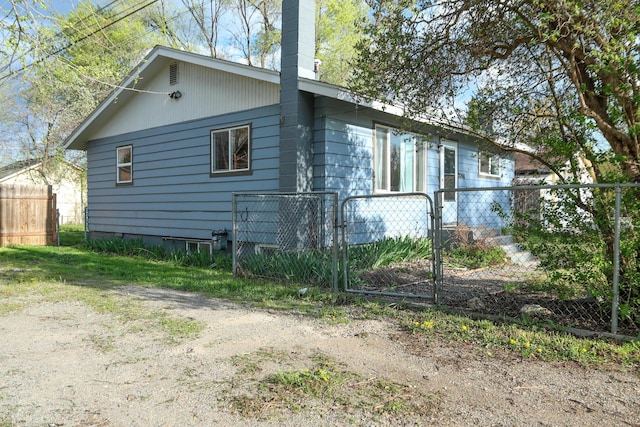 2060 Schilling St, Missoula, MT 59801 - view of property exterior featuring a gate, fence, and a chimney