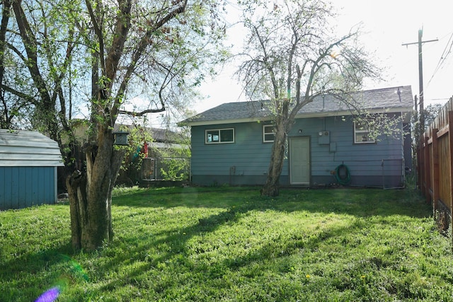 2060 Schilling St, Missoula, MT 59801 - rear view of property with a yard, fence, and an outbuilding