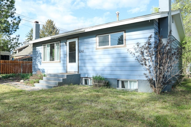 2060 Schilling St, Missoula, MT 59801 - view of front of house with fence, a chimney, and a front yard