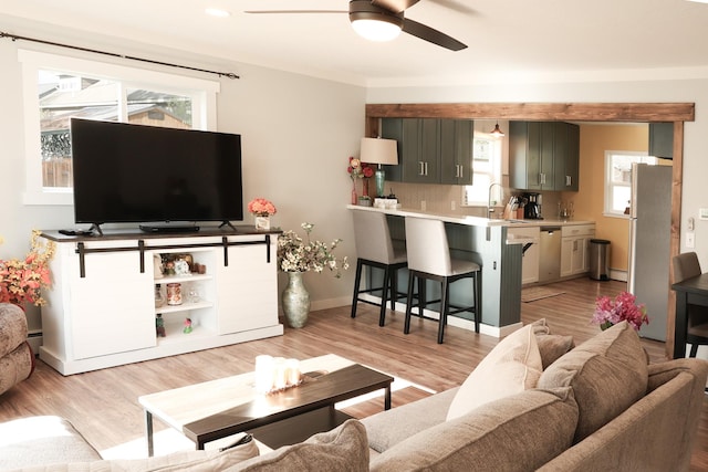 2060 Schilling St, Missoula, MT 59801 - living room with baseboards, ceiling fan, light wood-style flooring, and a wealth of natural light