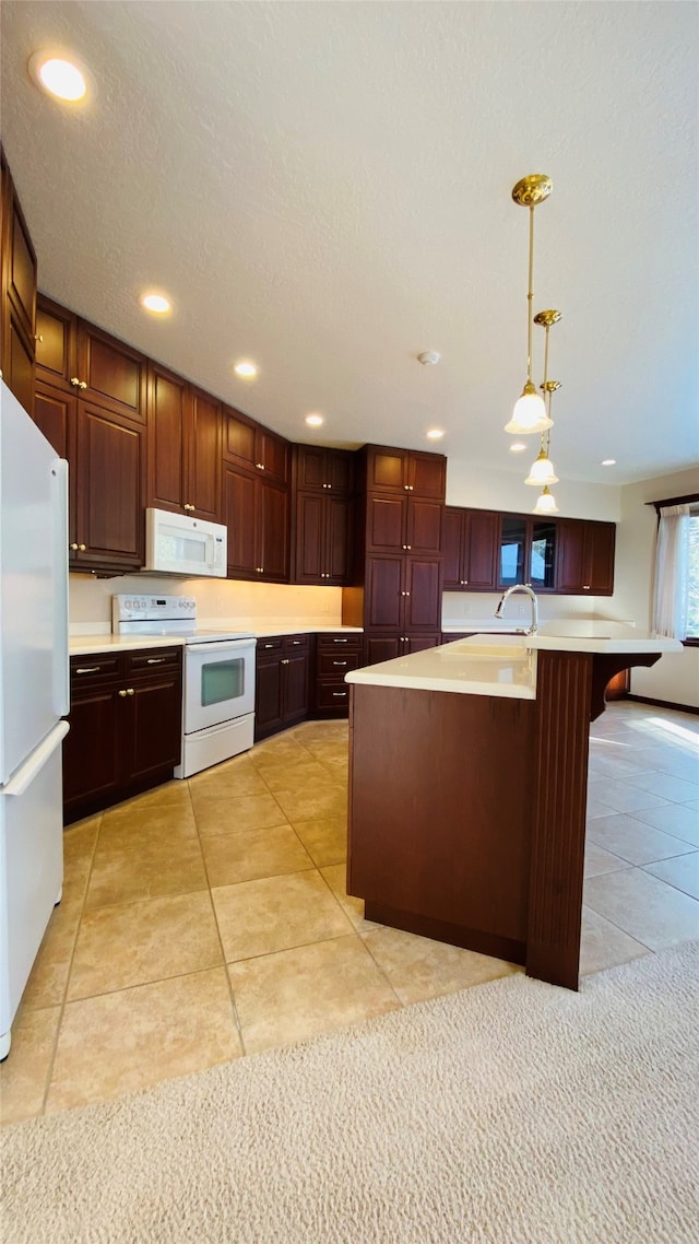 7 Brookside, Missoula, MT 59802 - kitchen featuring white appliances, recessed lighting, light countertops, light tile patterned floors, and hanging light fixtures