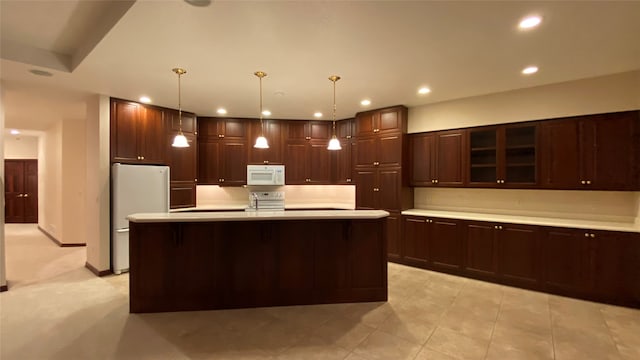 7 Brookside, Missoula, MT 59802 - kitchen featuring pendant lighting, light countertops, glass insert cabinets, recessed lighting, and white appliances