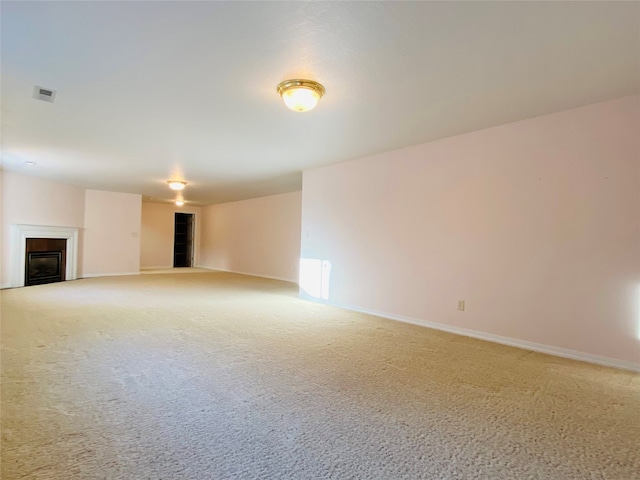7 Brookside, Missoula, MT 59802 - unfurnished living room featuring visible vents, baseboards, a fireplace, and light colored carpet