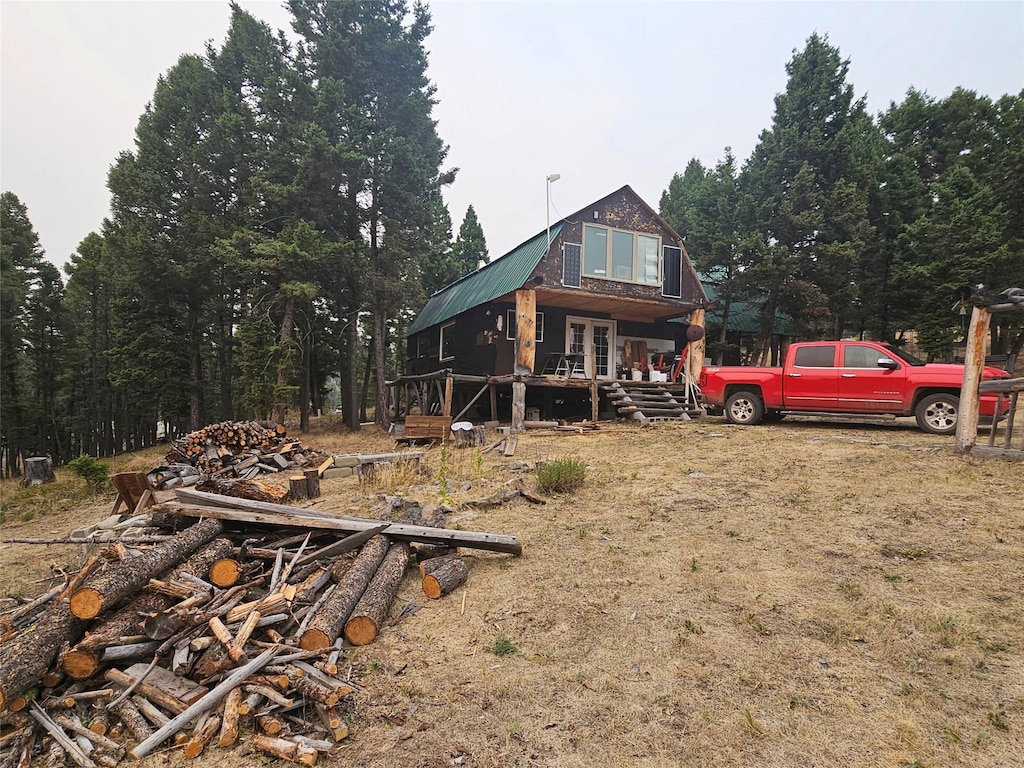 rear view of house with french doors and metal roof