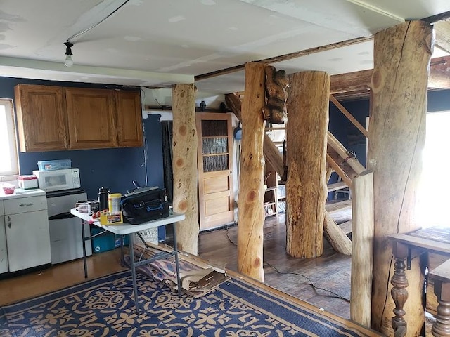 513 Spruce Gulch Rd, Helmville, MT 59843 - kitchen featuring white microwave, a desk, and brown cabinetry