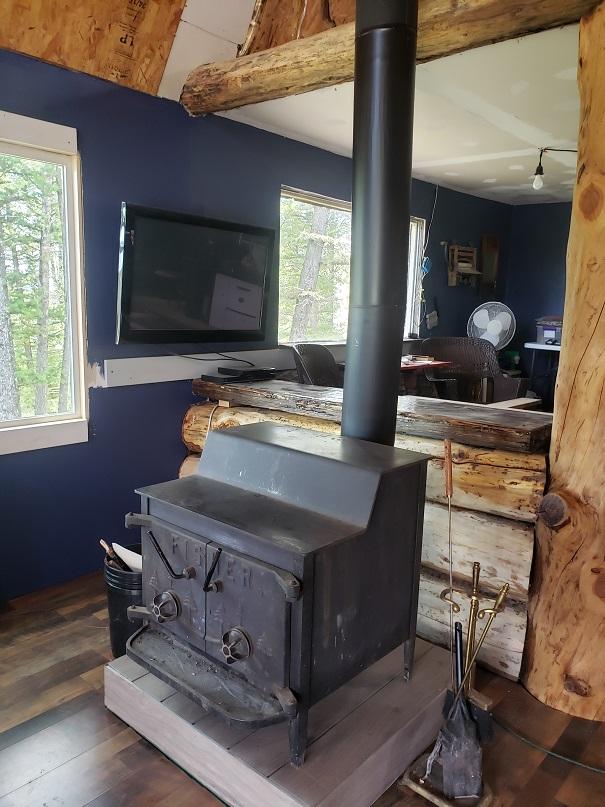 513 Spruce Gulch Rd, Helmville, MT 59843 - detailed view of a wood stove and wood finished floors