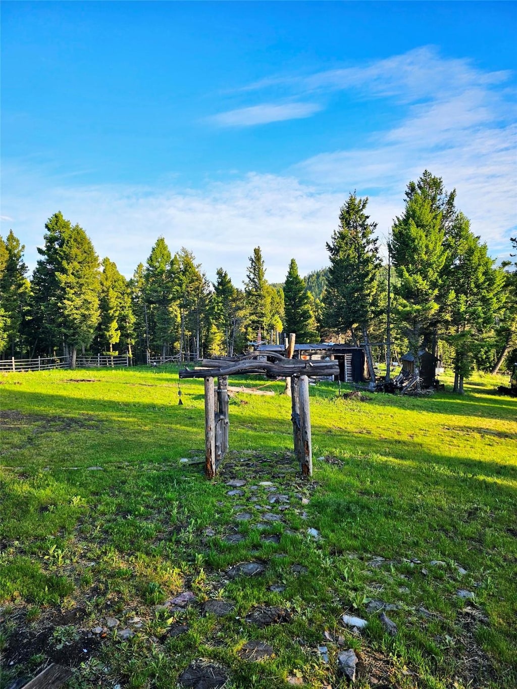 view of property's community featuring a lawn and fence