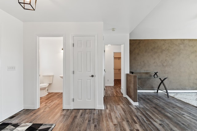 interior space with baseboards and dark wood finished floors