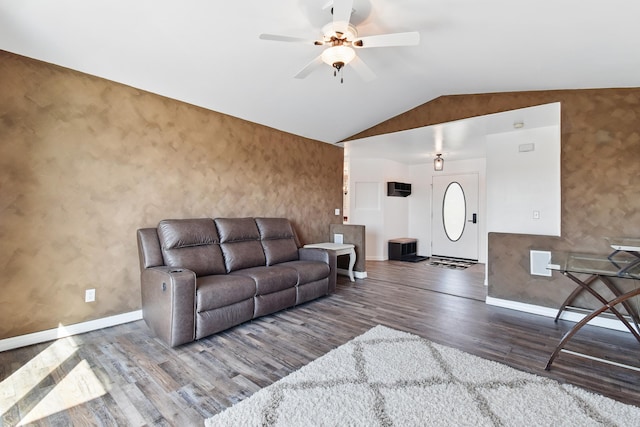 living room featuring baseboards, ceiling fan, wood finished floors, and lofted ceiling