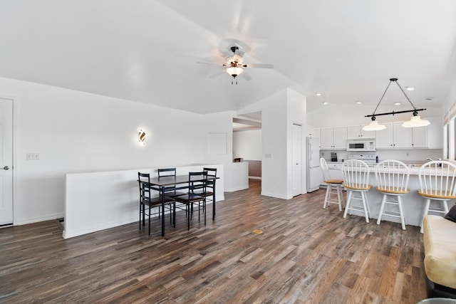 dining area with baseboards, recessed lighting, a ceiling fan, dark wood finished floors, and vaulted ceiling