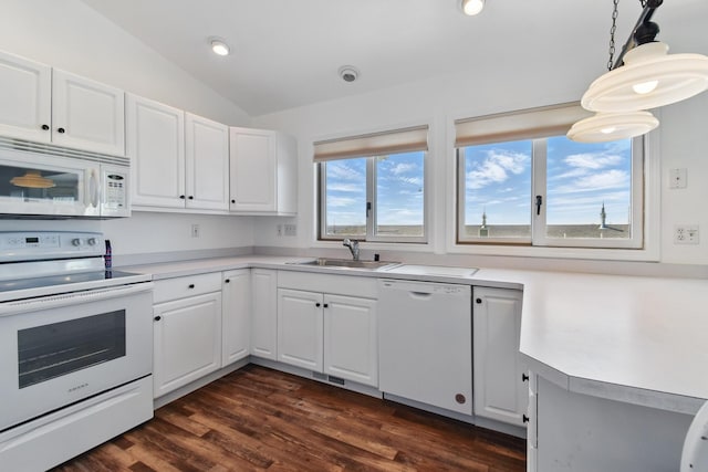 kitchen featuring a sink, light countertops, white cabinets, lofted ceiling, and white appliances