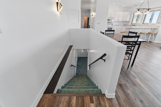 stairs with baseboards and wood finished floors
