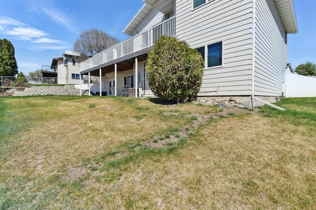 exterior space with fence, a yard, a deck, and cooling unit