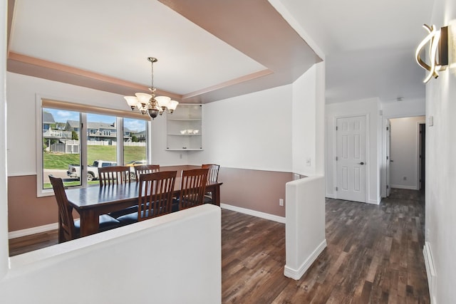 dining room with baseboards, a chandelier, and dark wood-type flooring
