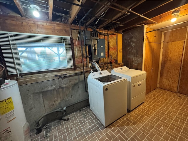 laundry room featuring laundry area, electric panel, water heater, separate washer and dryer, and brick floor